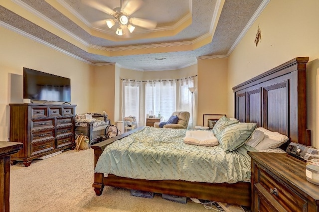 carpeted bedroom featuring crown molding, a ceiling fan, and a tray ceiling
