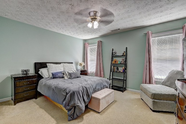 bedroom with light colored carpet, baseboards, and visible vents