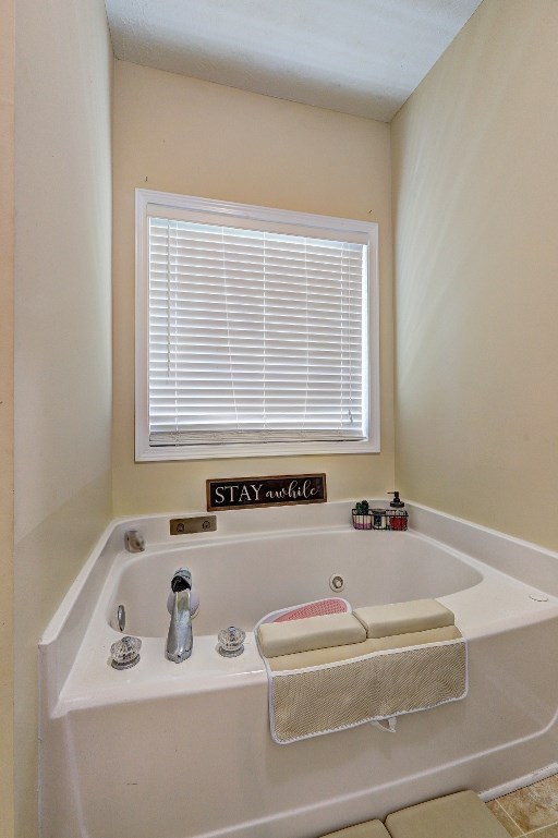 full bathroom with a garden tub and a wealth of natural light