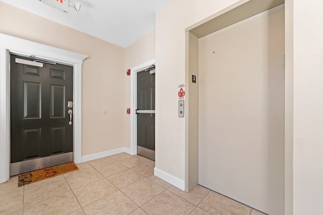 222 Sheffield Dr Unit E-5, Sparta, GA 31087 - entrance foyer with elevator, baseboards, and light tile patterned flooring