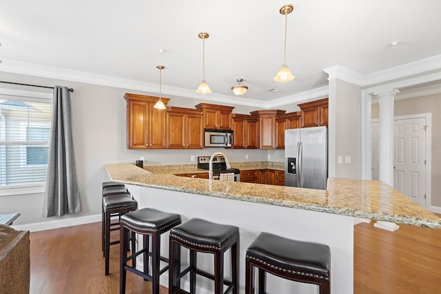 222 Sheffield Dr Unit E-5, Sparta, GA 31087 - kitchen featuring stainless steel appliances, a peninsula, a kitchen breakfast bar, and crown molding
