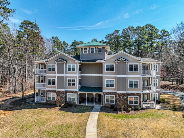 222 Sheffield Dr Unit E-5, Sparta, GA 31087 - view of front of home featuring stone siding, a front lawn, and a balcony