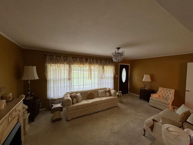 living room with ornamental molding, light colored carpet, and a notable chandelier