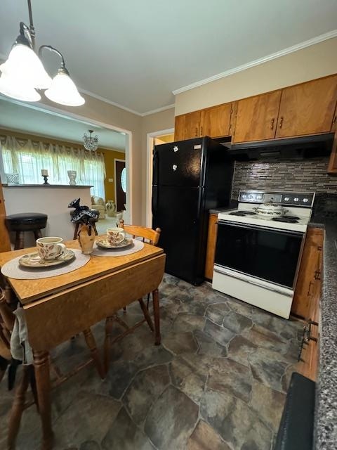 kitchen featuring black refrigerator, ornamental molding, white electric range oven, pendant lighting, and a notable chandelier