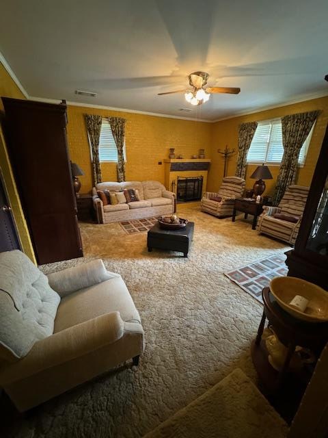 carpeted living room featuring crown molding and ceiling fan