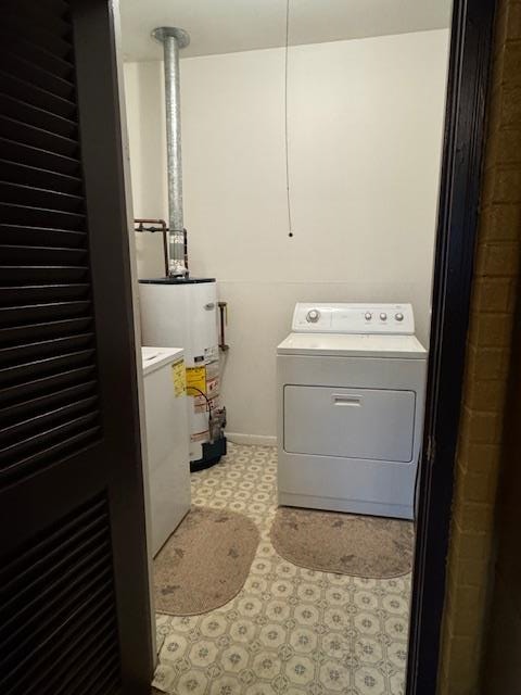 clothes washing area featuring washer / dryer and gas water heater