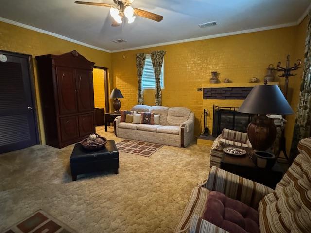 living room with ceiling fan, carpet floors, and crown molding