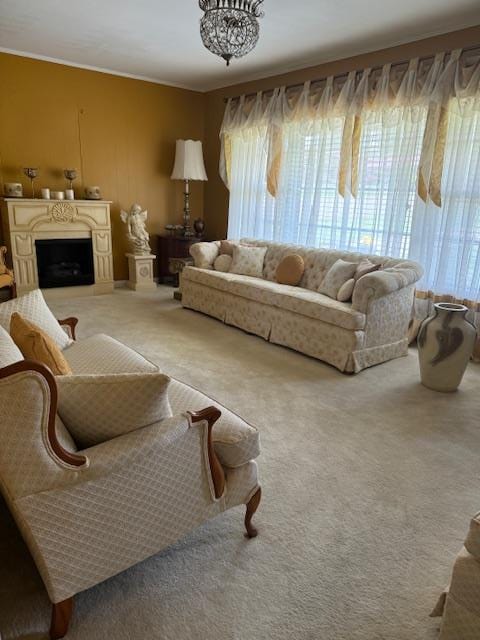 carpeted living room featuring an inviting chandelier