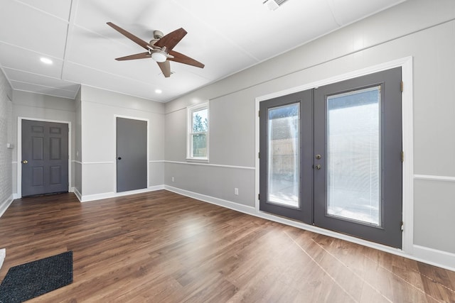 unfurnished room with baseboards, dark wood-style flooring, and french doors