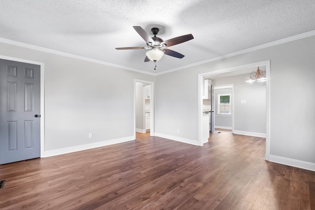 empty room featuring a textured ceiling, ornamental molding, dark wood-style flooring, and baseboards