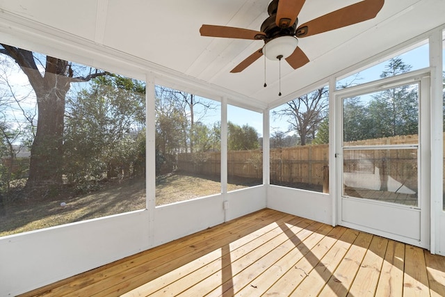 unfurnished sunroom featuring ceiling fan