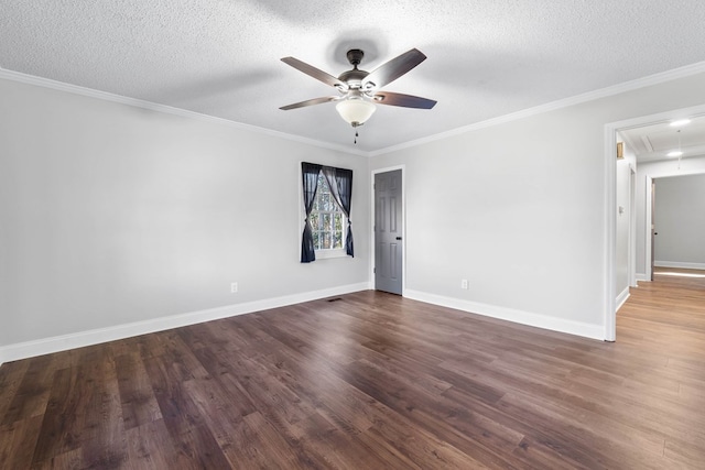 unfurnished room with attic access, a textured ceiling, ornamental molding, and dark wood-style flooring