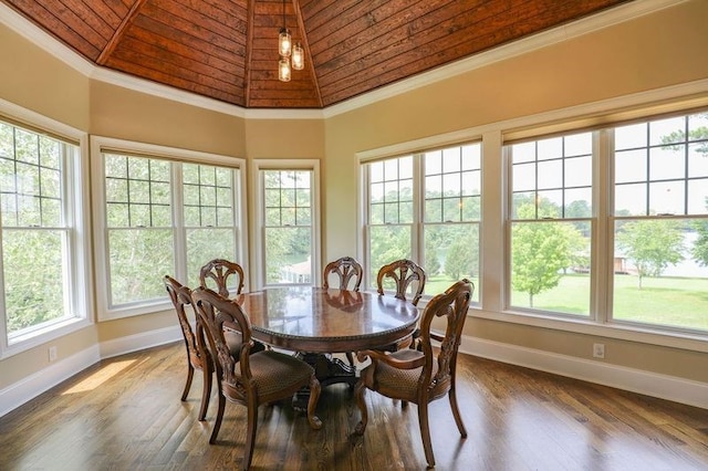 dining space with wooden ceiling, a high ceiling, a wealth of natural light, and ornamental molding