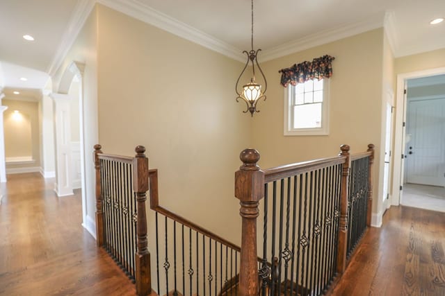 hall with dark hardwood / wood-style flooring and crown molding