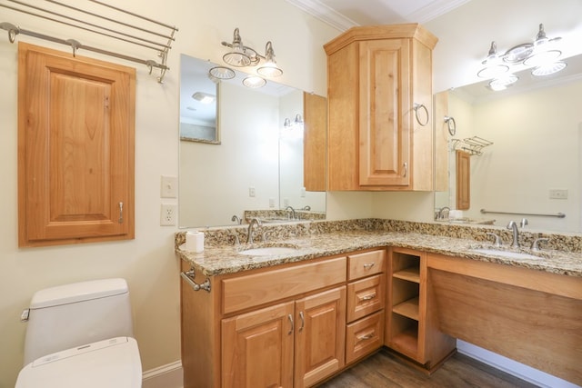 bathroom featuring crown molding, hardwood / wood-style floors, vanity, and toilet