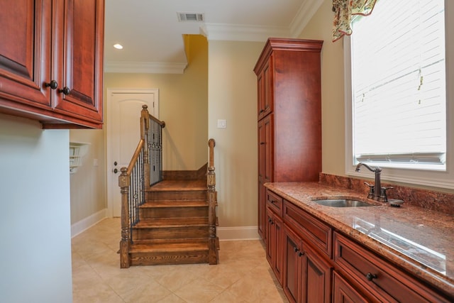 interior space with tile patterned floors, crown molding, and sink