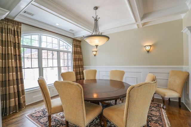 dining room featuring beamed ceiling, ornamental molding, a wealth of natural light, and coffered ceiling