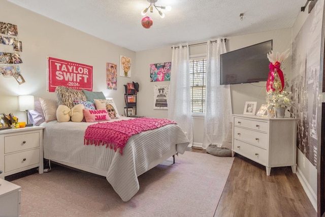 3657 Sussex Dr, Milledgeville, GA 31061 - bedroom with a textured ceiling and wood finished floors