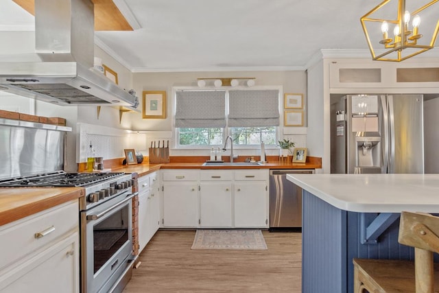 3657 Sussex Dr, Milledgeville, GA 31061 - kitchen with appliances with stainless steel finishes, a sink, white cabinetry, island exhaust hood, and light wood-type flooring