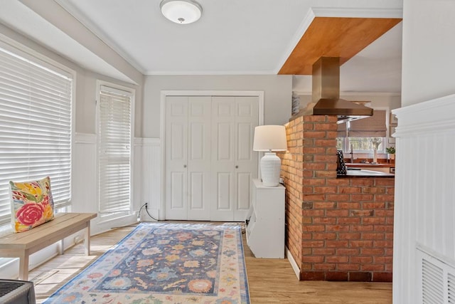 3657 Sussex Dr, Milledgeville, GA 31061 - entryway with ornamental molding, light wood-style flooring, and wainscoting