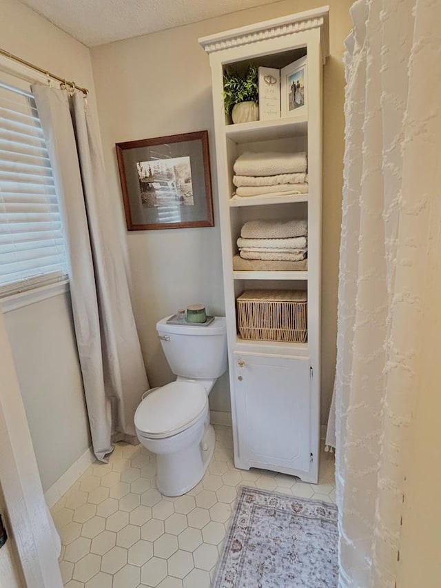 3657 Sussex Dr, Milledgeville, GA 31061 - bathroom featuring baseboards, tile patterned floors, and toilet