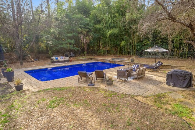3657 Sussex Dr, Milledgeville, GA 31061 - view of swimming pool featuring an outdoor living space, a fenced backyard, a patio area, and a pool with connected hot tub
