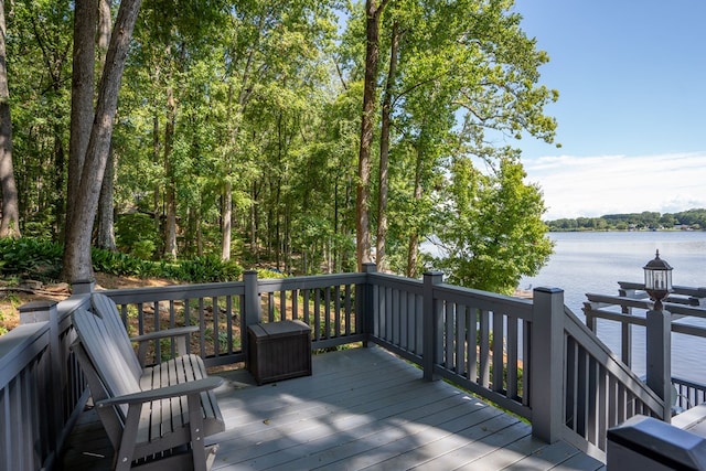 wooden terrace featuring a water view