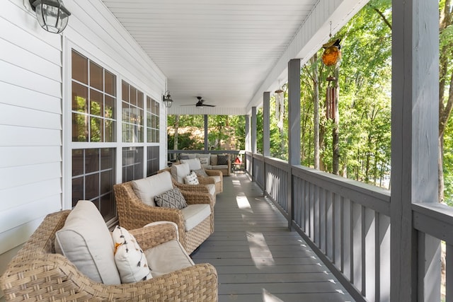 wooden deck with covered porch and ceiling fan