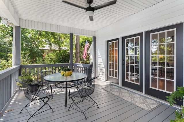 wooden deck featuring ceiling fan