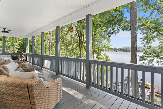 wooden deck featuring ceiling fan and a water view