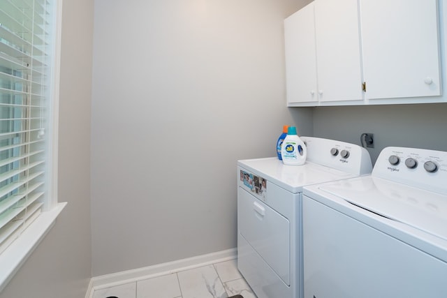 laundry room with washer and clothes dryer and cabinets