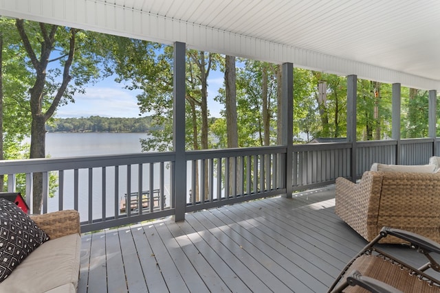 wooden terrace featuring a water view