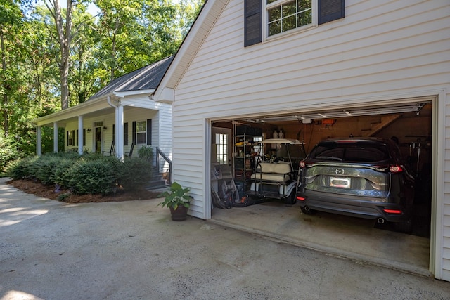 view of property exterior with a porch and a garage