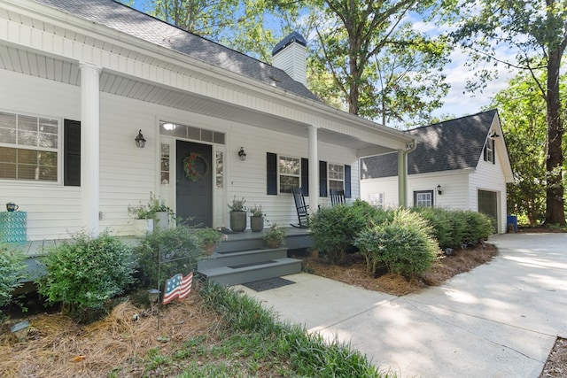 view of front of property with a garage and covered porch