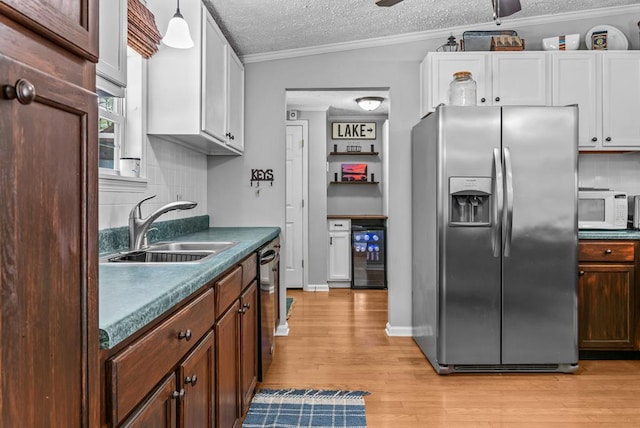 126A N Little River Run, Eatonton, GA 31024 - kitchen featuring stainless steel appliances, wine cooler, light wood finished floors, a textured ceiling, and decorative backsplash