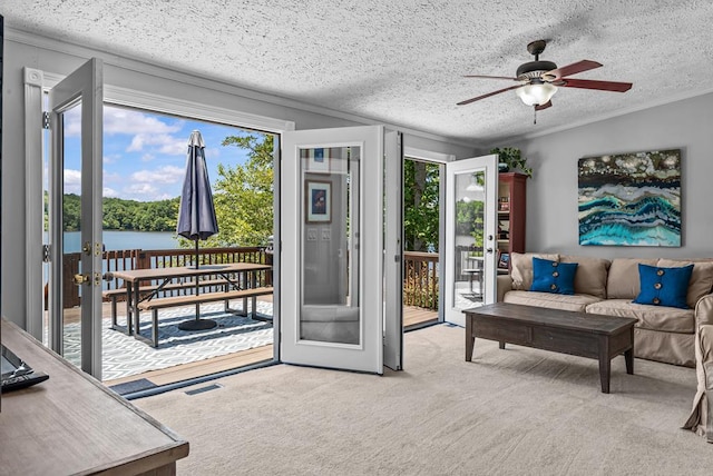 126A N Little River Run, Eatonton, GA 31024 - carpeted living room featuring plenty of natural light, a ceiling fan, crown molding, french doors, and a water view