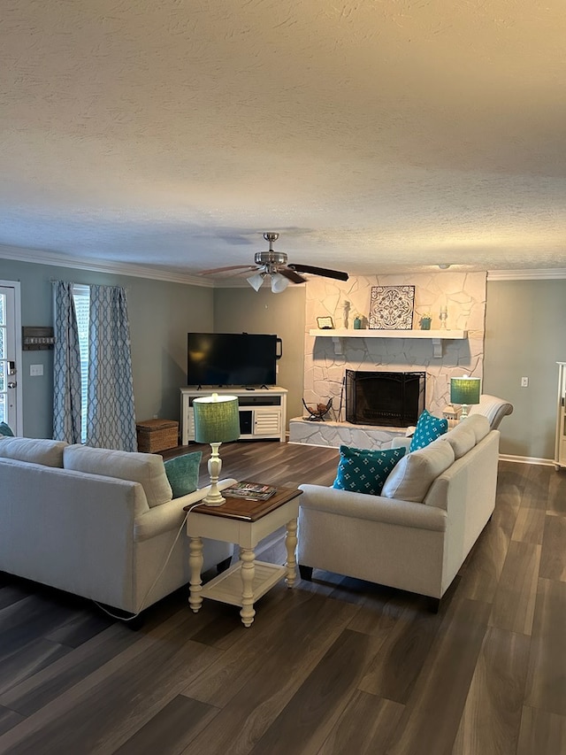 living room featuring a fireplace, dark hardwood / wood-style flooring, a textured ceiling, and ceiling fan