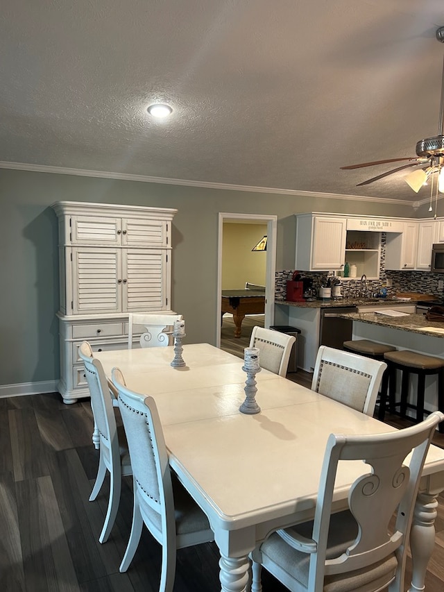 dining room featuring a textured ceiling, ceiling fan, crown molding, billiards, and dark hardwood / wood-style floors