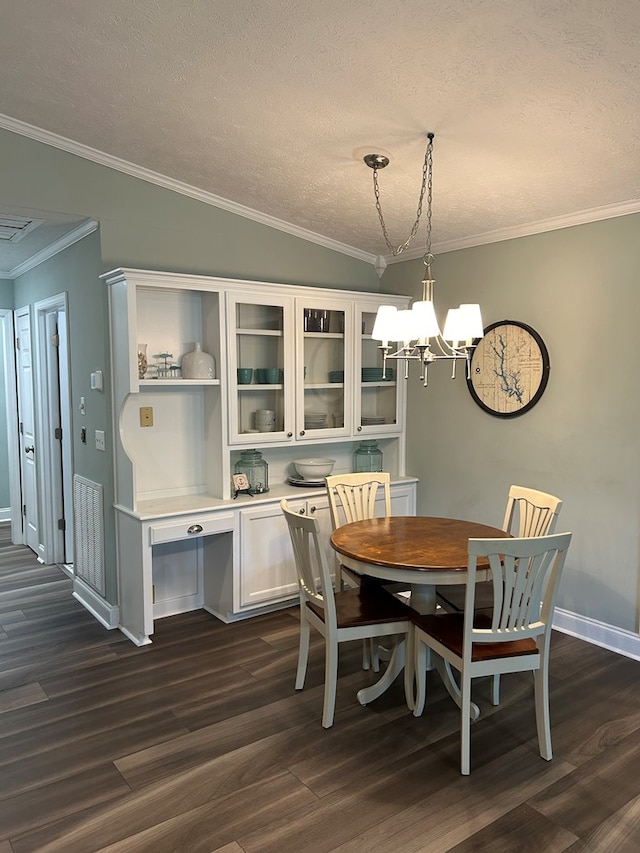 dining space featuring dark hardwood / wood-style flooring, a notable chandelier, crown molding, a textured ceiling, and vaulted ceiling