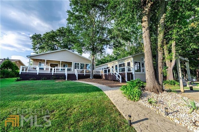 view of front facade with a front yard and a porch