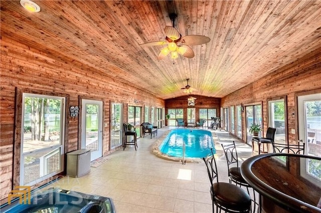 view of swimming pool featuring ceiling fan and an indoor hot tub