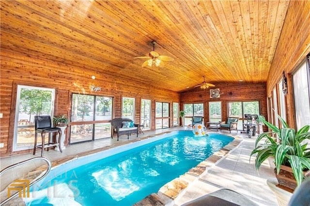 view of swimming pool with ceiling fan and a jacuzzi