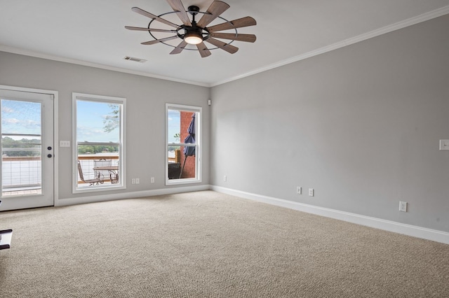 empty room with ceiling fan, carpet floors, and crown molding