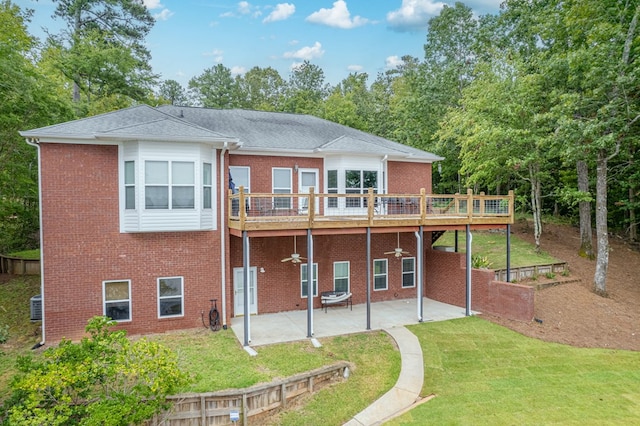 back of property with a patio, a lawn, and a wooden deck