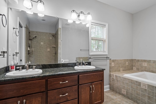 bathroom featuring tile patterned flooring, vanity, and independent shower and bath