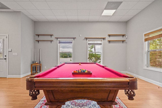 recreation room featuring light wood-type flooring, a drop ceiling, and billiards