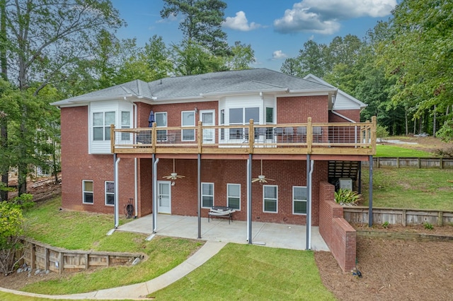 rear view of property with a lawn, ceiling fan, a patio, and a deck