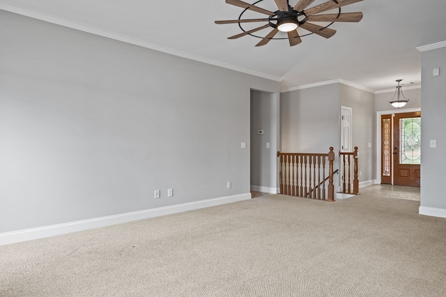 carpeted empty room with crown molding and ceiling fan