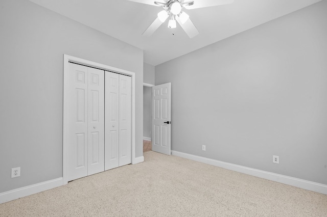 unfurnished bedroom with ceiling fan, a closet, and carpet