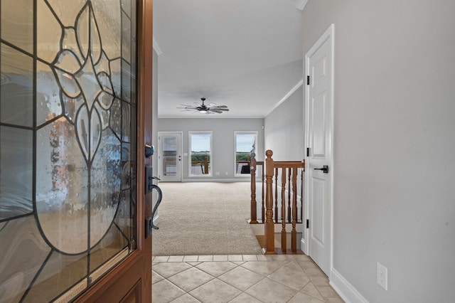 corridor featuring crown molding and light carpet